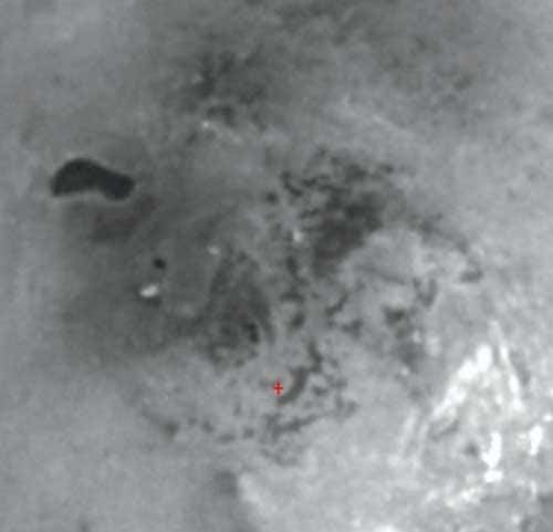 Titan's south polar region has an intriguing dark feature that may be the site of a past or present lake of liquid hydrocarbons. Resolution in the scene is 3 kilometres (2 miles) per pixel.