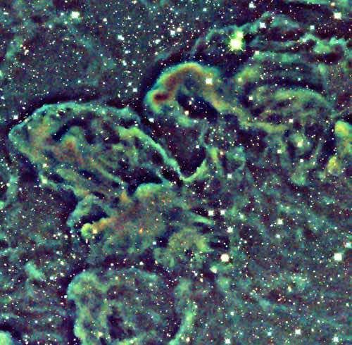 Light from surrounding stars scatters off particles in the clouds, producing