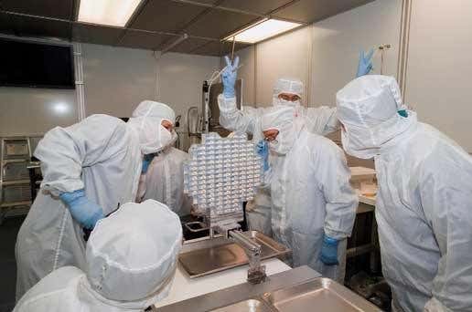 Scientists examine Stardust's Aerogel collector in a clean room at Johnson Space Center in Houston, Texas 