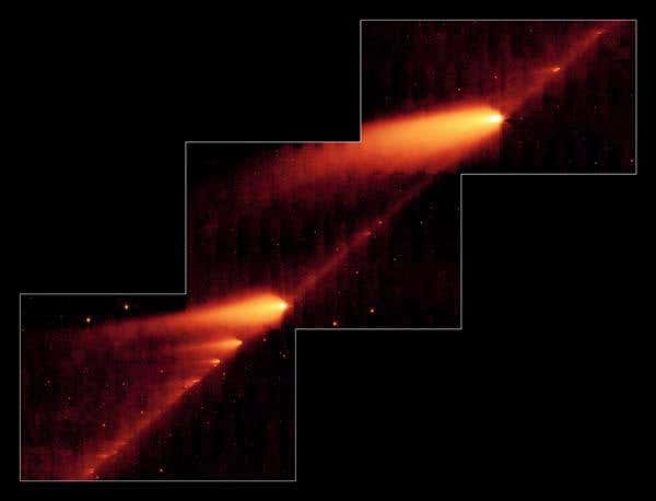 This infrared image from the Spitzer Space Telescope shows the 73P skimming along a trail of debris left during its multiple trips around the Sun. The flame-like objects are the comet's fragments and their tails