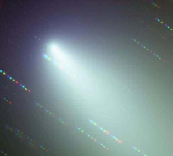 An optical wavelength image of the broken objects surrounding Fragment B of Comet 73P, using blue, violet, red and indigo filters