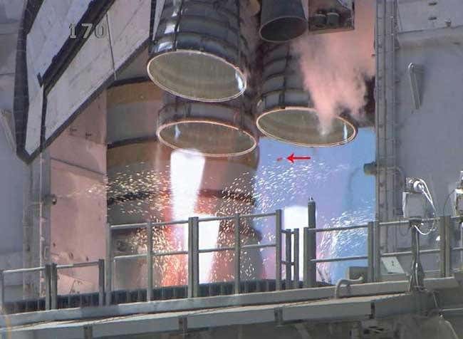 A small piece of falling debris (arrowed) is believed to be a part of a shim used on the thermal protection system of the shuttle orbiter. NASA says the piece did not cause damage and the loss will not be a concern for the mission or landing 