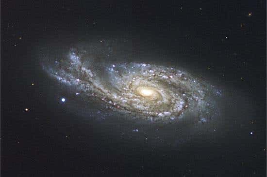 The spiral arm on the left side of galaxy NGC 908 has been bent upwards by a near-collision with a passing galaxy 