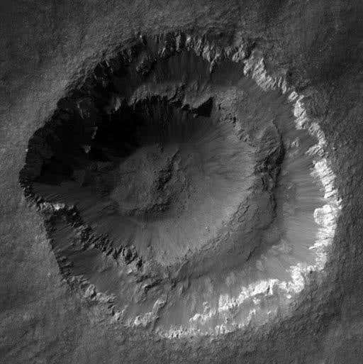 Ada Crater is puzzling because it has features indicating it is very young, yet its rim is as eroded as those of much older craters. It also has a strange double rim, whose origin is unknown