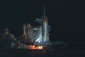 Space shuttle launch lights up night sky