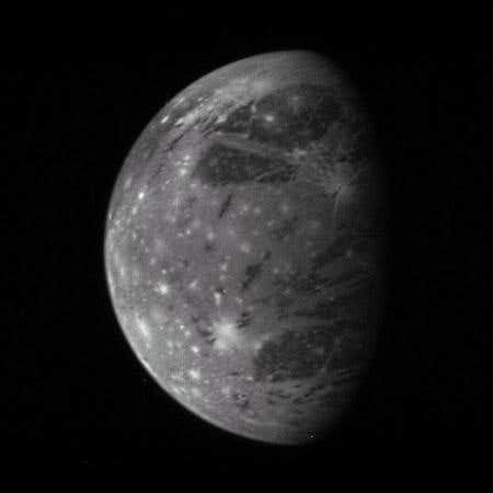 The granddaddy of solar system satellites, Ganymede, shows off old dark material as well as brighter young terrain and bright pockmarks left over from meteoroid impacts