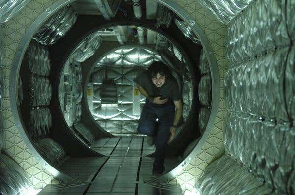 Capa, wounded in the Icarus II, struggles down the corridor