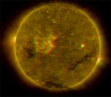 STEREO snapped a 3D image of the full disc of the Sun, which shows three holes in its outer atmosphere, or corona. The holes appear dark in part because they contain fewer particles that emit light 