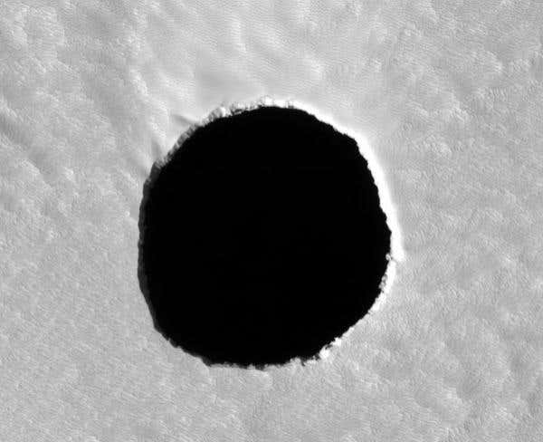 The first image of the dark feature showed no signs of any walls, leaving open the possibility that it was the entrance to a larger cavern