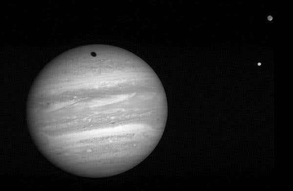 Jupiter's largest moon, Ganymede, casts a shadow on the gas giant in this image by the New Horizons spacecraft