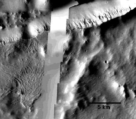 On the left side of this image from NASA's Mars Odyssey spacecraft, rock formations show ridges parallel to what was once probably a mud flow in Mars's Cerberus Fossae region 