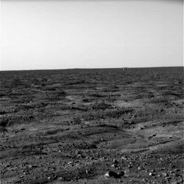 Is the bright white object in the distance the lander's protective backshell?