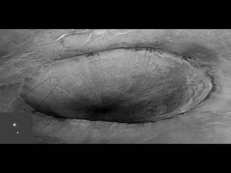 Phoenix appears to be parachuting into a giant crater, but it's only an optical illusion - the lander was actually 20 km in front of the crater when the image was taken 