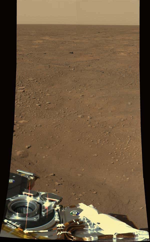 Phoenix took this colour image on Tuesday showing part of the lander against the Martian landscape