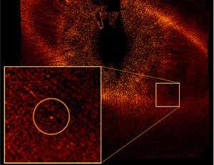 A ring of dust and debris surrounding the star Fomalhaut (whose light is blocked out) appears here in an optical image taken with the Hubble Space Telescope in 2006. A planet (inset) orbits the star about three times as far from its star as Pluto does from the Sun - a separation larger than that of any other confirmed exoplanet 