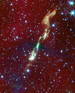 An infrared view of a developing star and its flaring jets, taken by NASA's Spitzer Space Telescope. The image shows us what our own solar system might have looked like billions of years ago; the star, L1157, is only thousands of years old. In visible light, this star and its surrounding regions are completely hidden in darkness 