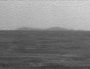 The Mars rover Opportunity caught a glimpse of its distant quarry, Endeavour Crater, on the horizon earlier this month. The large, rimmed crater is still 12 kilometres away as the crow flies, the same distance Opportunity has driven in its five years on the Red Planet