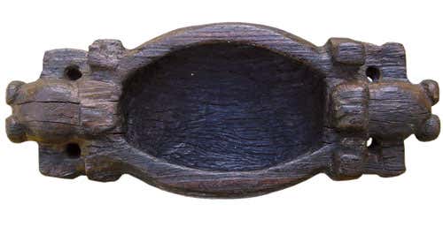 This wooden vessel with elaborately carved handles was found at Los Buchillones 
