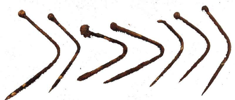 Eight bent brass pins from the bottle, the longest 3.2 centimetres