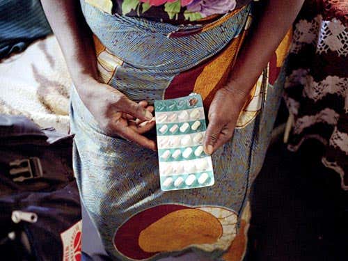 A patient holds her HIV/AIDS antiretroviral (ARV) drugs 