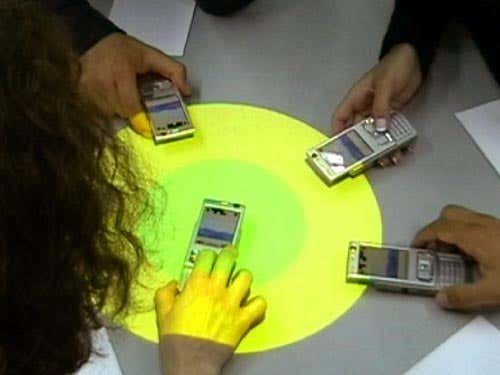 It in your hands. Researchers demonstrate the photo sharing system at the University of Newcastle