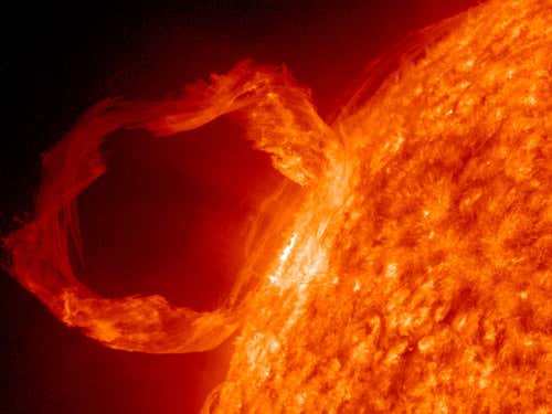 A prominence eruption on the sun: an arc of gas can loop hundreds of thousands of kilometres into space, held for months by strong magnetic fields