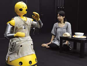 Humanoid robot Wakamaru (left), produced by Japan's Mitsubishi Heavy Industry, and human actor Minako Inoue (tight) take part in a drama written and directed by playwright Oriza Hirata at Osaka University in Japan in 2008 (Image: Yoshikazu Tsuno/AFP/Getty