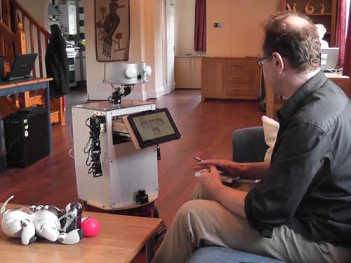 Playfully flashing its LEDs and playing a perky tune, the Sunflower robot opens its chest drawer to deliver our man some meds (hair restorer?)