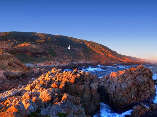 The entrance of Blombos cave on the coast of the Indian Ocean