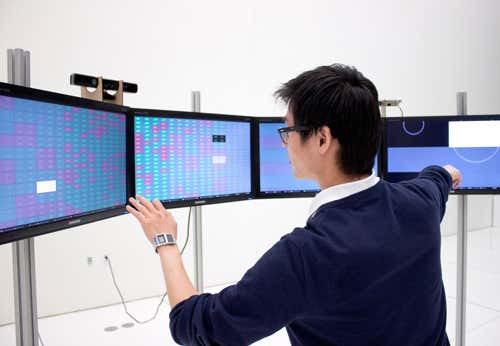 Person looking at a row of computer monitors