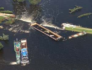 Scuppered barges plug dyke to hold back German flood