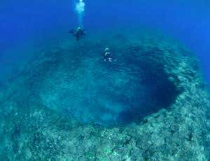 Plunge deep into an undersea mountain crater