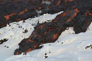 Red hot lava battles snow as Russian volcano erupts