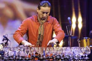 Submerge a wine glass in water to make 'inverted harp of glass'