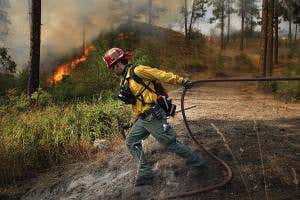 US wildfires continue to spread as high winds foil simulations