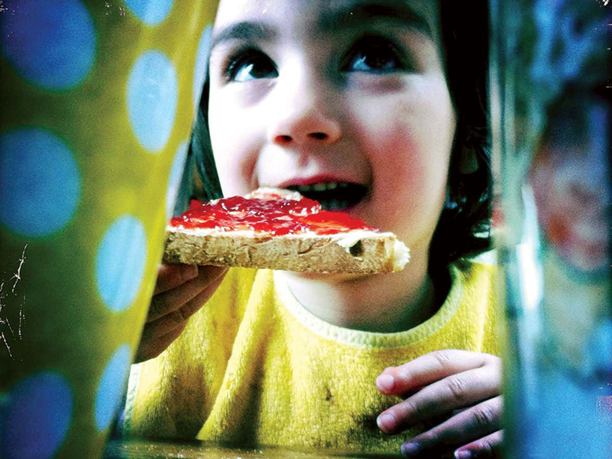 Girl eating jam sandwich