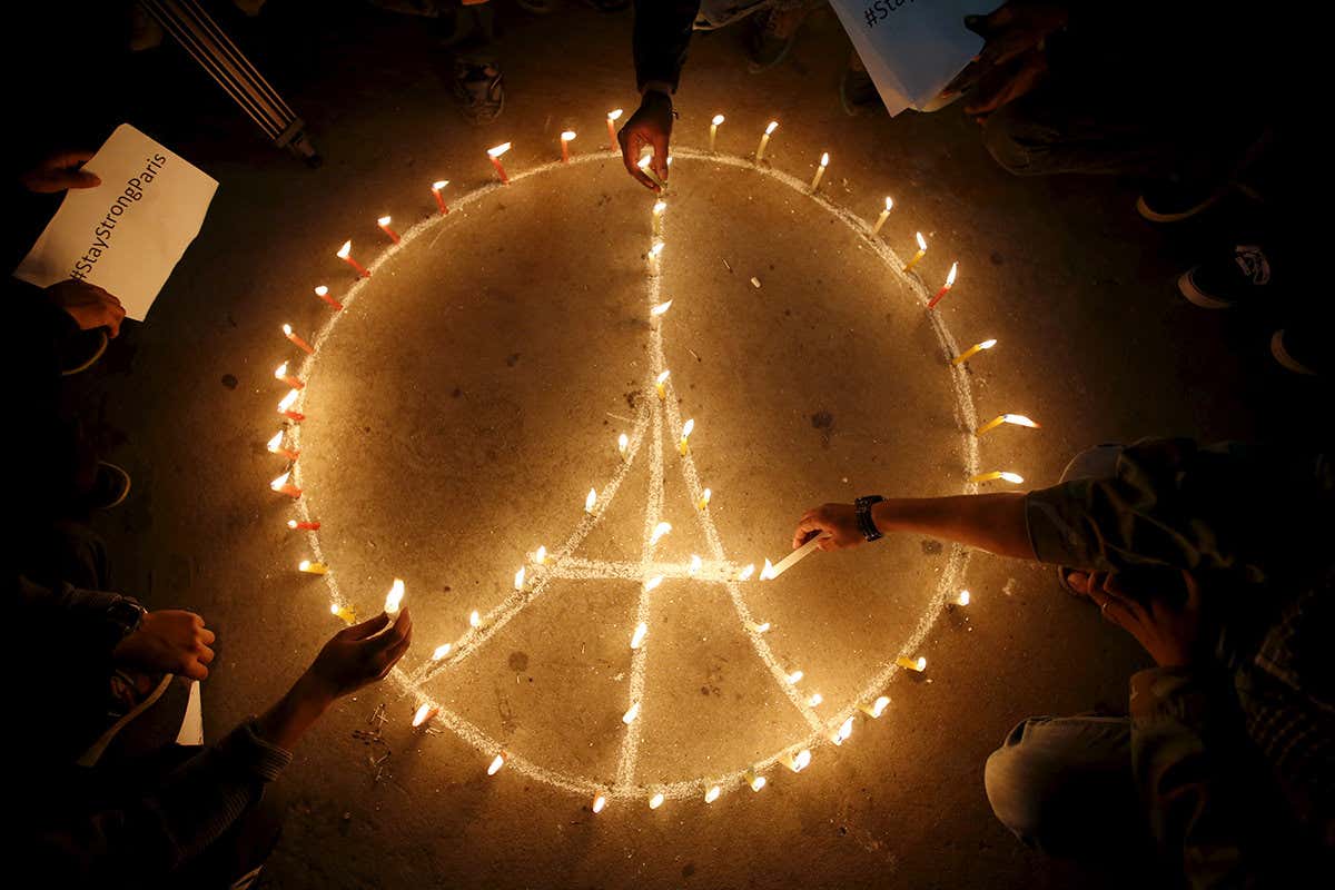 Candles in the shape of a peace symbol at a memorial for the terror attacks in Paris in November 2015