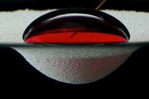 Raft made of dust carries water droplets across a sea of oil