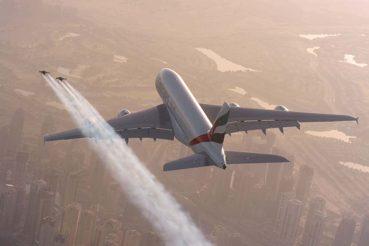 Two men flying over Dubai using jetpacks