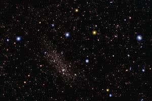 Giant galaxy caught tearing apart its little neighbour