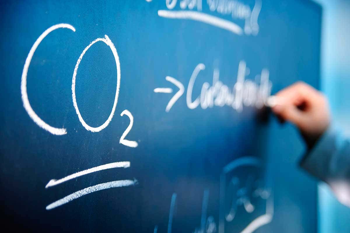 The formula for carbon dioxide drawn on a chalkboard