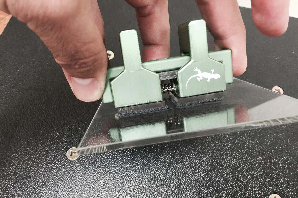 A close-up of the actual Gecko Gripper. It's quite small and you can just about see that it's got two fuzzy-looking surfaces which appear to be gripping a piece of glass