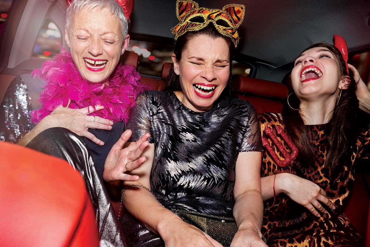 A gorup of women in costumes laughing