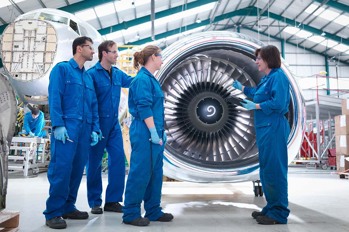 Engineers in front of an engine