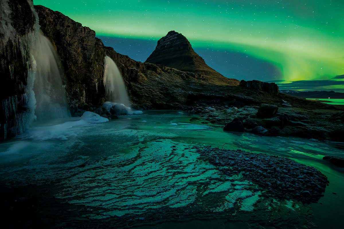 Northern Lights over Icelandic rocky landscape