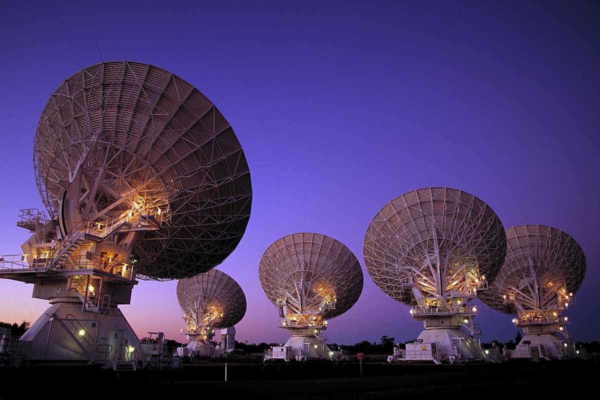 An array of radio telescopes points at the sky
