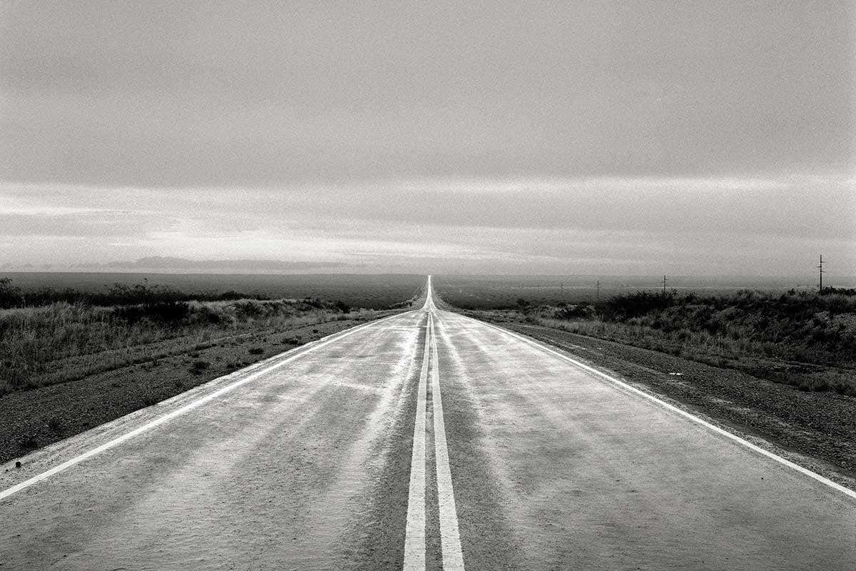 A long straight road carries on into the distance