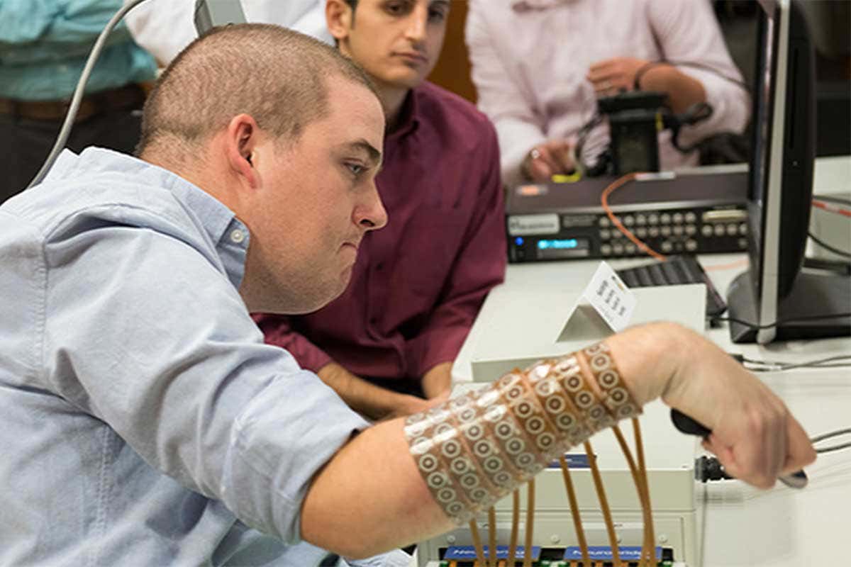 Ian Burkhart moves his hand using a sleeve of electrodes attached to implant in his brain