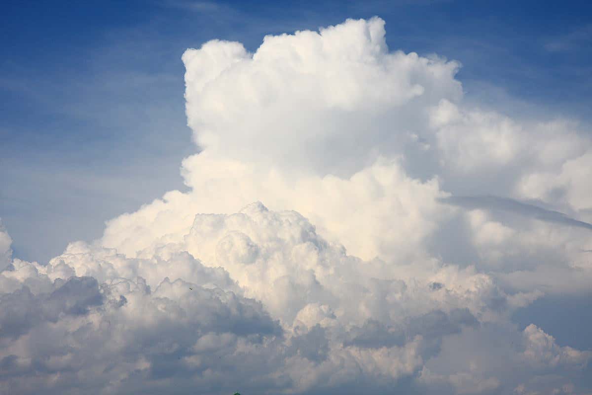 Stack of white puffy clouds against blue sky