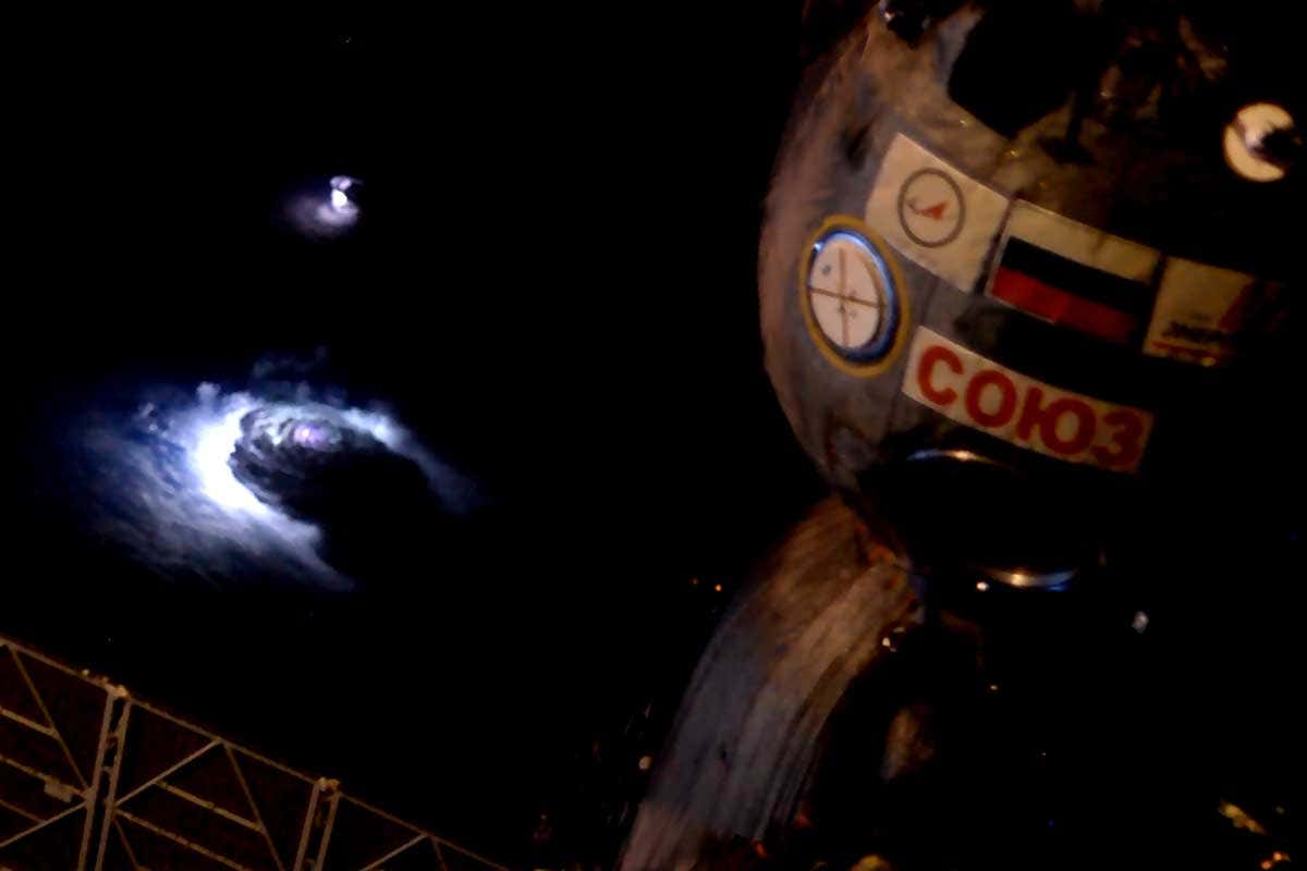 A blue glow in the clouds, as seen from the window of the ISS